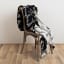 La Porte Blanche Reversible Monochrome Hubbell Knitted Throw, 130cm x 200cm on the chair