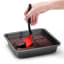 Dreamfarm Mini Chopula Spatula - Red lifiting the chocolate brownie