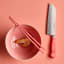 Wusthof Classic Santoku, 17cm - Coral Peach on the table with a bowl and chopsticks 