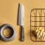 Wusthof Classic Santoku, 17cm - Velvet Oyster on the table with a grinding stone 