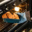 Olala Silicone Glove taking out the hot croissants from the oven