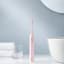 Usmile Sonic Electric Toothbrush Y1S - Pink with face towels next to the basin