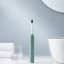 Usmile Sonic Electric Toothbrush Y1S - Green with face towels next to the basin