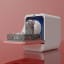 Daan Tech Bob Eco-Compact Dishwasher - Pink Pastel angled with dishes on the table