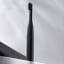 PomaDent PomaBrush Electric Toothbrush Set  - Carbon on the table