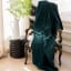 Linen House Decadence Fur Throw - Emerald hanging on the chair