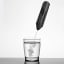 Creative Cooking Handheld Milk Frother with a glass of water