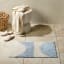 Linen House Cue Bathmat - Blue on bathroom floor next to basket