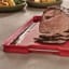 Joseph Joseph Cut and Carve Plus Chopping Board, Large - Red with sliced steak