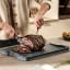 Joseph Joseph Cut and Carve Plus Chopping Board, Large - Sky on the table slicing some steak