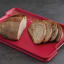 Joseph Joseph Cut and Carve Plus Chopping Board, Large - Red with sliced bread