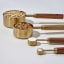 Trendz Of Today Gold & Wood Measuring Cup and Spoon Set showing scale