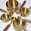 Trendz Of Today Gold & Wood Measuring Cup and Spoon Set on the table