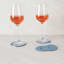 Project Dyad Contour Coaster, Set of 4 - Blue on the table with wine glasses