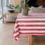 Linen House Revana Red Stripe Tablecloth - 6 Seater on the table with a pot plant