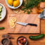 Wusthof Classic Asian Utility Knife, 12cm on the chopping board with sliced lemons and other ingredients