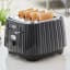 DeLonghi Ballerina 4-Slice Toaster, 1800W - Furnace Black on the table with toasted bread