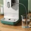 Smeg Bean-to-Cup Automatic Coffee Machine with a Milk System - Matte Emerald Green detail on the counter 