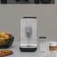 Smeg Smeg Bean-to-Cup Automatic Coffee Machine with a Milk System - Matt Black on the table with coffee