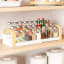 Umbra Bellwood Three-Tier Spice Shelf on kitchen shelf with spices