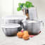 Tovolo Stainless Steel Mixing Bowls with Tight Seal Lids, Set of 3 on the kitchen counter with eggs