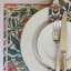 Caversham Textiles Paradise Floral Paper Placemats - A3 on the table with a plate