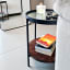 Native Decor Fluted Glass Side Table with books and remotes