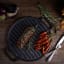 Victoria Seasoned Round Reversible Cast Iron Griddle, 32cm on the table with food