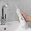 Waterpik Cordless Advanced Water Flosser on the counter top basin