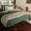 Thread Office Knitted Cotton Throw - Ivory on the bed