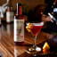 Luckybird Cosmopolitan Cocktail Mixer, 750ml with a cocktail glass on a bar counter