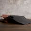 La Porte Blanche Black Croc-Embossed Leather Coaster, Set of 4 on the table with Turin Luxe Brown coasters