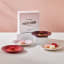 Le Creuset La Collection Petits Fours Appetiser Plates, Set of 4 on the table with sweet treats