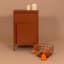 Popstrukt Bon Bon Buddy Side Table - Terra with candles and a waffle basket 