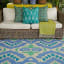 India Ink Green & Blue Ancient Ikat Rug with a couch