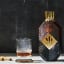 Virginia Black Decadent American Whiskey, 700ml on the table with a glass