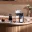Nespresso Vertuo Lattissima Coffee Machine - White on the kitchen counter with coffee