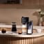 Nespresso Vertuo Lattissima Coffee Machine - Black on the kitchen counter with coffee