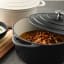 Sagenwolf Enamelled Cast Iron Casserole Pot, 28cm - Matt Black on the table with butter chicken