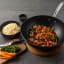 Sagenwolf Titanium Series Non-Stick Wok with Lid, 32cm - Black with prawns on the table