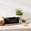 Le Creuset Signature Cast Iron Loaf Pan, 23cm - Matte Black on the table with baking ingredients