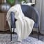 Linen House Teddy Throw - Ivory on a chair