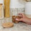 KitchenCraft Idilica Glass Storage Jar with Beechwood Lid - Small with almond nuts