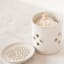 KitchenCraft Idilica  Stoneware Garlic Storage Jar with a Grater Lid with garlic on the table