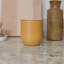 KitchenCraft Idilica Metal Storage Canister, 450ml - Yellow on the kitchen counter