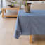 Linen House Revana Chambray Navy Tablecloth with a plant on the table