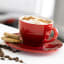 Le Creuset Cappuccino Cup and Saucer, Set of 2 on the table with ccookies