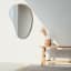 Umbra Hubba Pebble Mirror - Metallic Titanium In A living Room Setting 