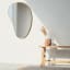 Umbra Hubba Pebble Mirror - Brass In A Living Room Setting 