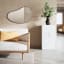 Umbra Hubba Pebble Mirror - Metallic Titanium In A living Room Setting 